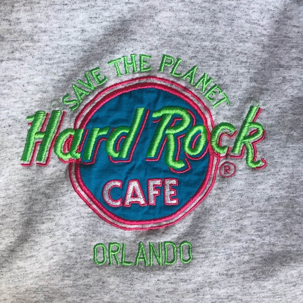 Light grey Hard Rock Cafe cropped raw hem sweater.